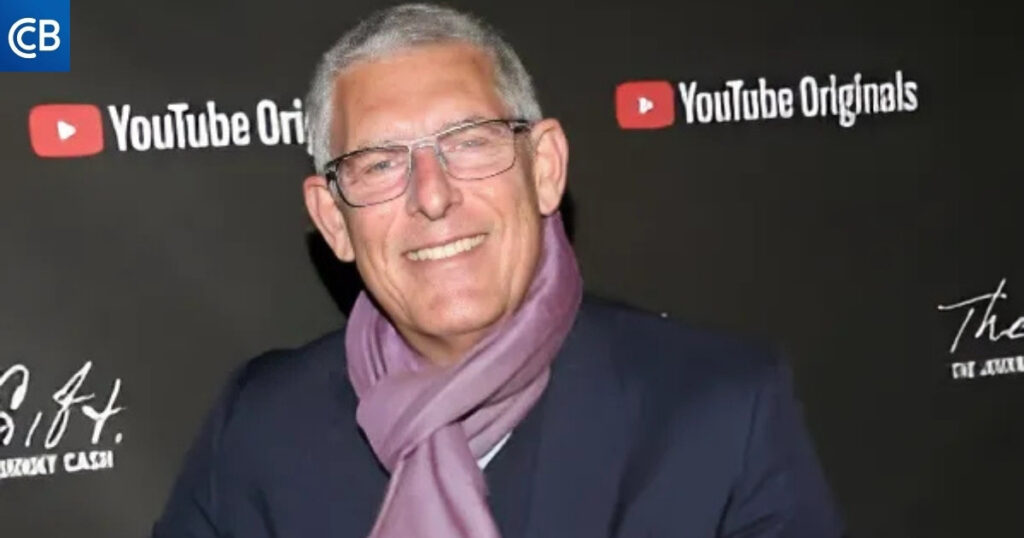 a person with glasses and a scarf is smiling