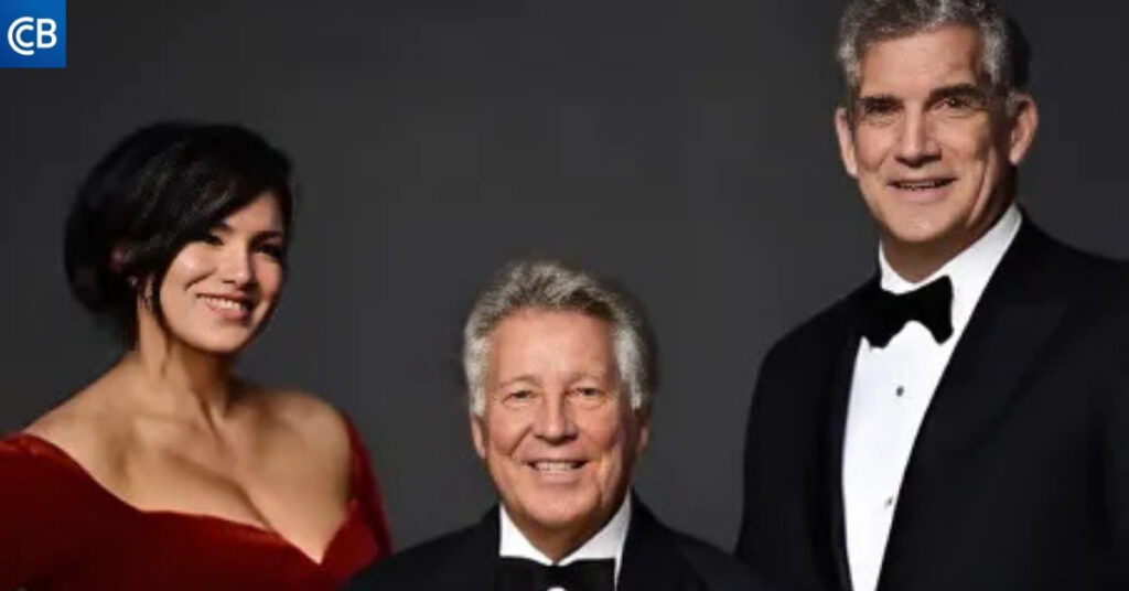 three people in tuxedos standing next to each other