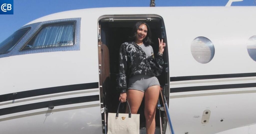 a person standing on the steps of a private jet