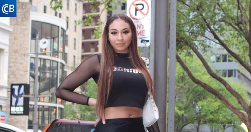 a person in a black top and skirt standing on the street